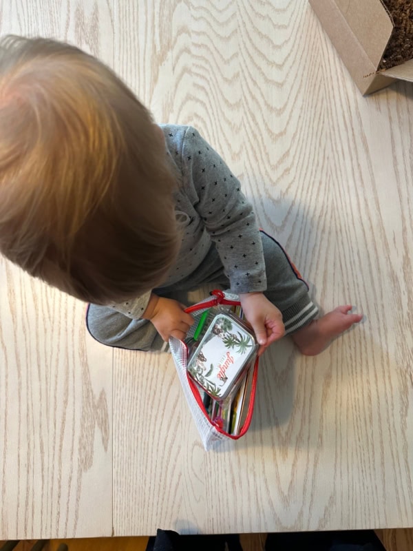 Baby playing with jungle tin