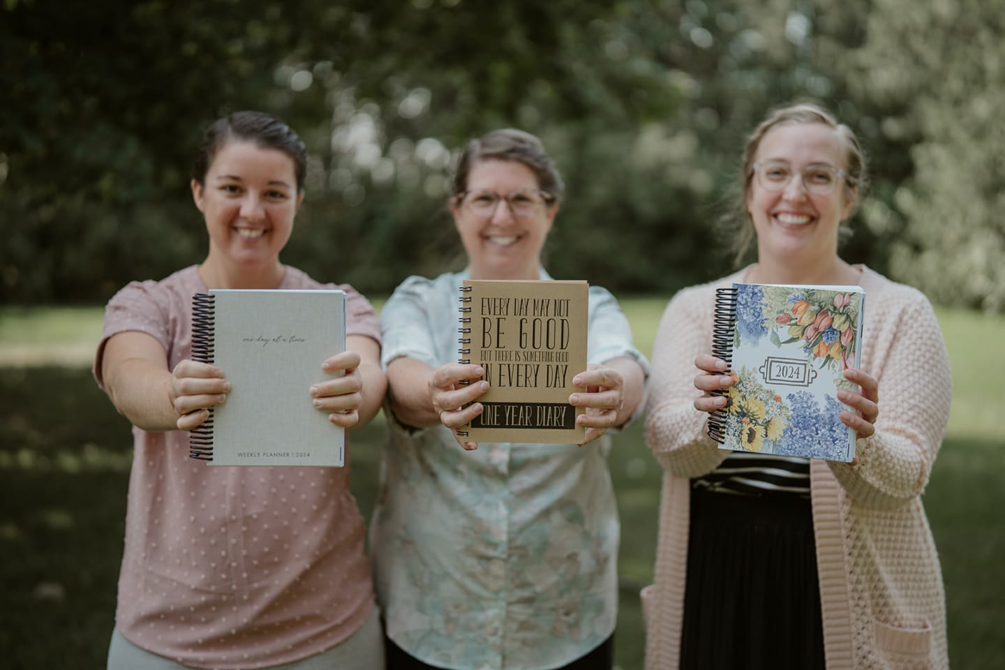 Lucretia, Carmen, and Sadie holding 2024 planner