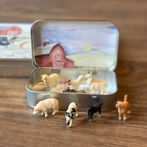 Mini Farm Animal Tin with animals open on a table