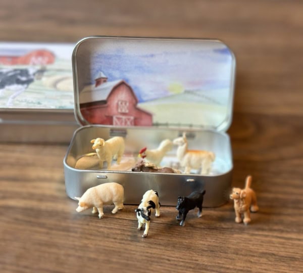 Mini Farm Animal Tin with animals open on a table