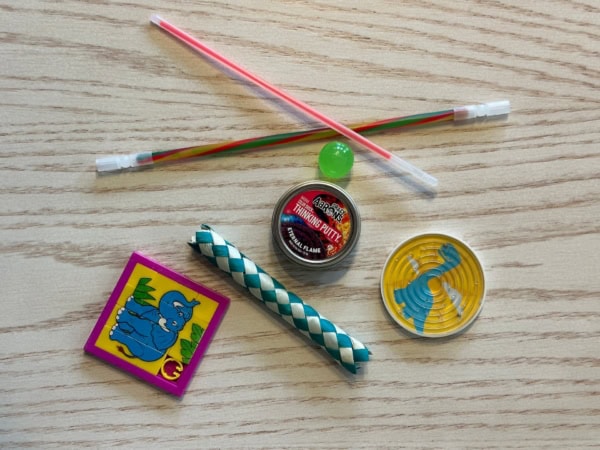 Assorted games. Ball maze, glow sticks, slide puzzle, bouncy ball.