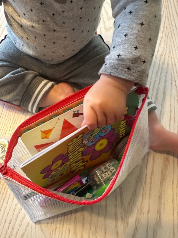 Baby playing with summer road trip kit.